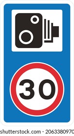 Speed camera ahead on an unlit road and reminder that 30 mph speed limit, road signs in the United Kingdom