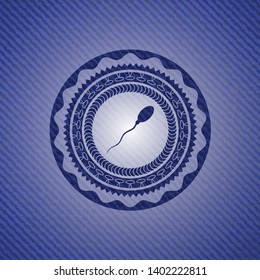 sperm icon inside badge with denim background