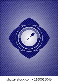 sperm icon inside emblem with denim texture