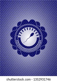 sperm icon inside emblem with jean background