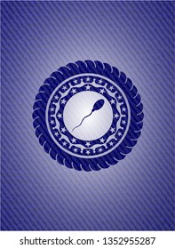 sperm icon inside emblem with jean background