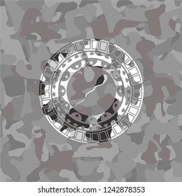sperm icon inside grey camo emblem