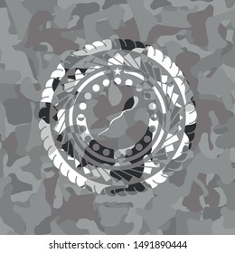 sperm icon inside grey camouflage emblem