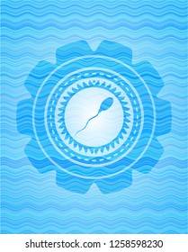 sperm icon inside light blue water wave emblem background.
