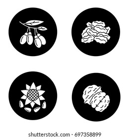 Spices glyph icons set. Sunflower seeds, raisins, goji berries, walnut. Vector white silhouettes illustrations in black circles