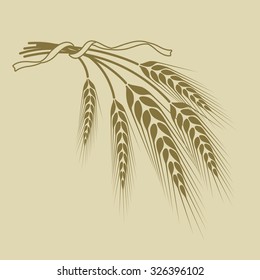 spikelets of wheat tied with a ribbon on a beige background