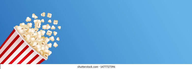 Spilled Popcorn on blue background. Copy space. Cinema Popcorn. Vector banner