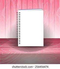 Spiral bound notepad. Vector template. Easy to place your image on the cover. Pink wooden background.