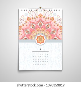 Spiral calendar with a round ornament.  Paisley ornament with peacock feathers elements and paisley
