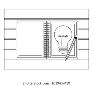 spiral notebook with light bulb in sheet and pencil over desk on top view in black contour