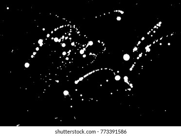 Splashes of ink on isolated black background. Vector texture.