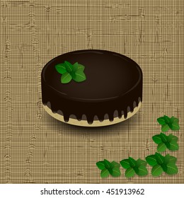 sponge cake with chocolate icing drizzled with a sprig of mint on the texture background