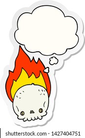 spooky cartoon flaming skull with thought bubble as a printed sticker