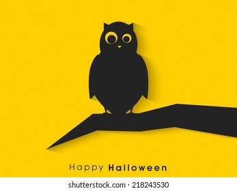 Spooky owl sitting on tree branch for Halloween night party celebrations. 