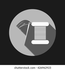 spool of thread and needle. a symbol of fashion and sewing.