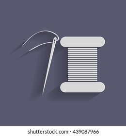 spool of thread and needle. a symbol of fashion and sewing.