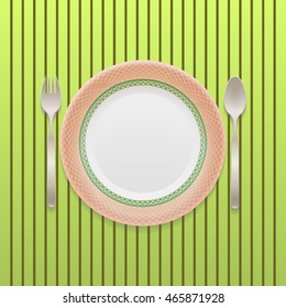 Spoon, fork and plate 
isolated on a striped green background