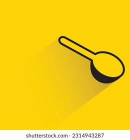 spoon with shadow on yellow background