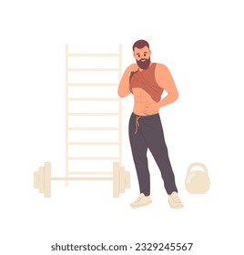 Sportive hipster man bragging his strong abs muscle after physical workout exercise at gym