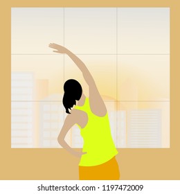 Sportive young woman exercising on the background of city view outside the window at sunrise