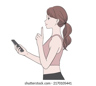 A sports instructor holding a smartphone and raising his index finger