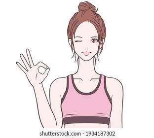 Sports instructor who makes an OK mark with a smile 