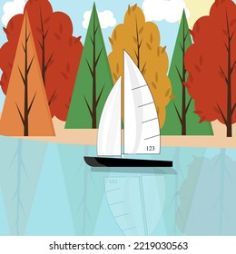 A sports sailboat with reflection on the lake against the background of an autumn forest, a blue sky with the sun and clouds. Autumn landscape with a yacht. 