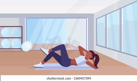 sports woman doing press exercises on mat african american girl training in gym aerobic workout healthy lifestyle concept flat modern health club studio interior horizontal