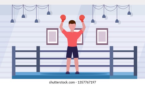 sportsman in red gloves raised hands professional male boxer celebrating successful fight victory concept boxing ring arena interior horizontal full length