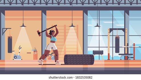 sportswoman hitting tire with hummer girl doing hard exercises working out fitness training healthy lifestyle concept modern gym interior horizontal full length vector illustration