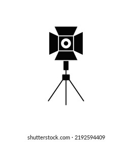 Spotlight on tripod icon in black flat glyph, filled style isolated on white background