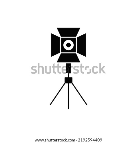 Spotlight on tripod icon in black flat glyph, filled style isolated on white background