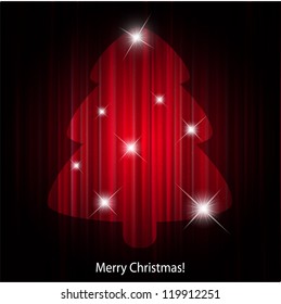 Spotlight xmas tree on red stage curtain.