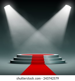 spotlights illuminate the pedestal with red carpet