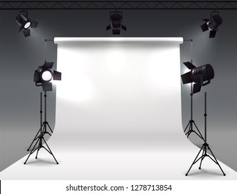 Spotlights realistic composition with cyclorama and studio spot lights hanging on reel and mounted on stands vector illustration