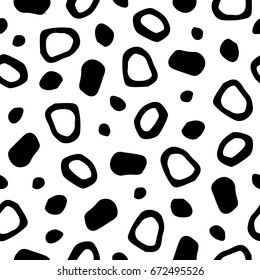 Spotted abstract seamless vector pattern with free hand drawn spots, specks, flecks, mots, stains of different size and shape. Uneven pieces texture. Cute natural forms black and white background.