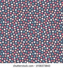Spotted pattern background. Vector geometric seamless repeat design of hand drawn polka dots in warm colours. Abstract multi directional decorative resource of dotted shapes. 