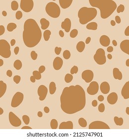 Spotted seamless pattern with beige background. Light brown cowboy digital paper with cow spots,  vector childish background for fabric, textile.