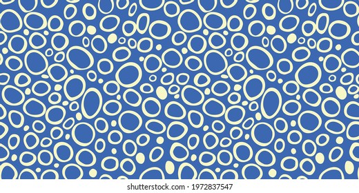 Spotty abstract vector seamless pattern. Random rings, dots, circles, spots, stains, bubbles, stones. Design for fabric, funny cute print. Irregular random texture. Repetitive graphic background