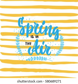 Spring is in the Air - hand drawn lettering phrase with branches isolated on the white background. Fun brush ink inscription for photo overlays, greeting card or t-shirt print, poster design