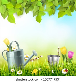 Spring background with leaves, watering can and flowers in the grass