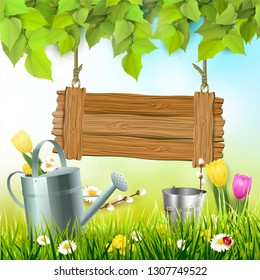 Spring background with leaves, wooden sign and watering an in the grass