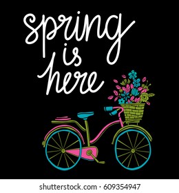 Spring card. Bicycle. Basket with flowers hand drawn. Isolated on black background. Hand written text, lettering