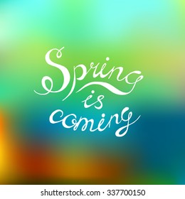 Spring is coming had written vector text, calligraphy lettering on blurred background