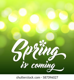 SPRING IS COMING Hand lettered style spring background. Handmade vector calligraphy on abstract glowing green background with bokeh light