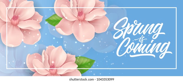 Spring is coming lettering in frame with pink blossoms on blue background with sparkles. Calligraphic inscription can be used for greeting cards, postcards, posters, banners.
