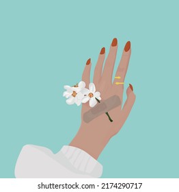 Spring flowers attached to a hand with plaster bands. Natural freshness and woman hand. Hands cosmetics with white flower adhesive plaster. Concept-natural therapy. Hand with golden ring