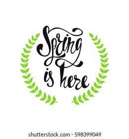 Spring is here calligraphic text with wreath. Hand written inspirational phrase.