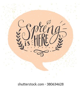 'Spring is here' hand lettering with decorative elements in a speech bubble. Funny typographic design card.