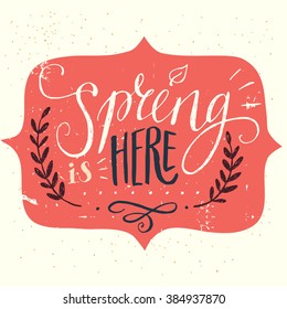 'Spring is here' hand lettering with decorative elements isolated on white background. Funny typographic design card.